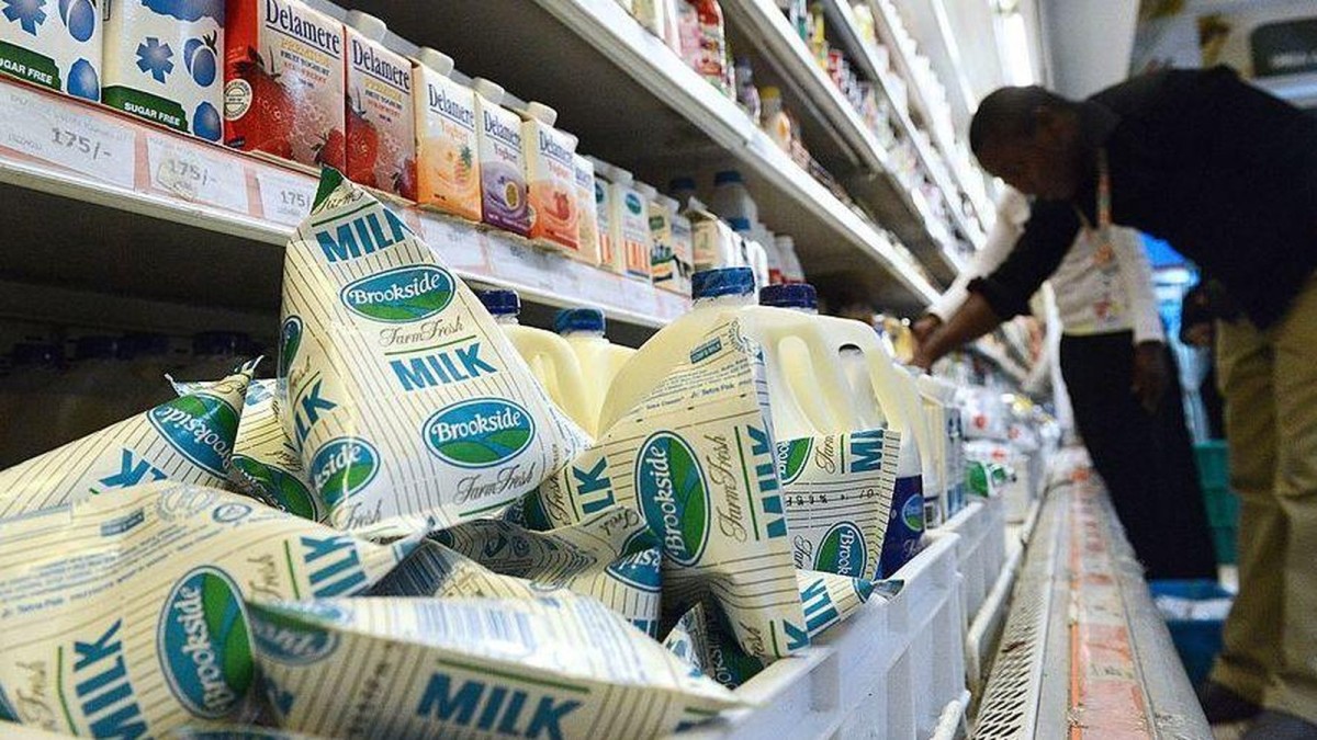 A shopper browsing dairy products in a Nairobi supermarket