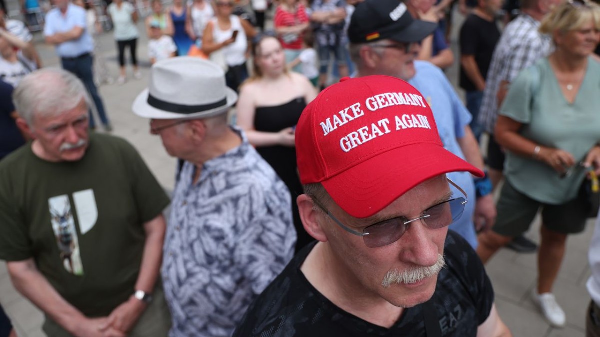 A supporter wears a cap reading Make Germany Great Again at an AfD campaign event in Berlin on July 31, 2026