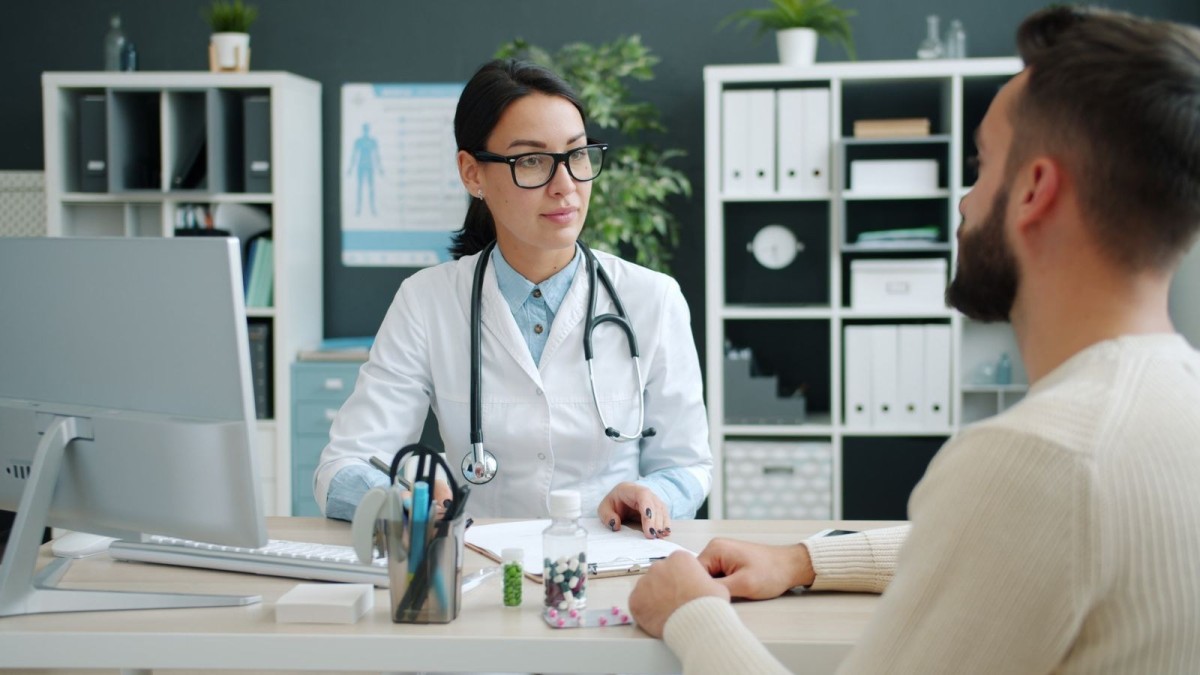 A doctor and patient discuss HIV treatment and care in a modern clinic in Thailand