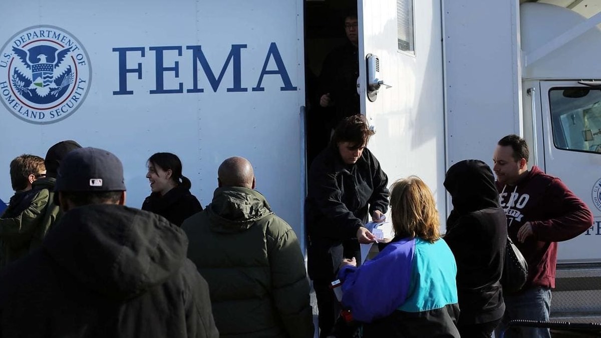 FEMA personnel handing out supplies at a disaster assistance distribution point