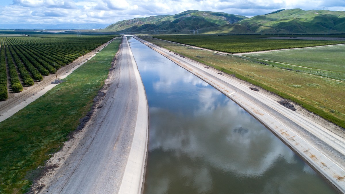 An aerial view of the concrete-lined California Aqueduct cutting through farmland and orchards. Photo: California Department of Water Resources