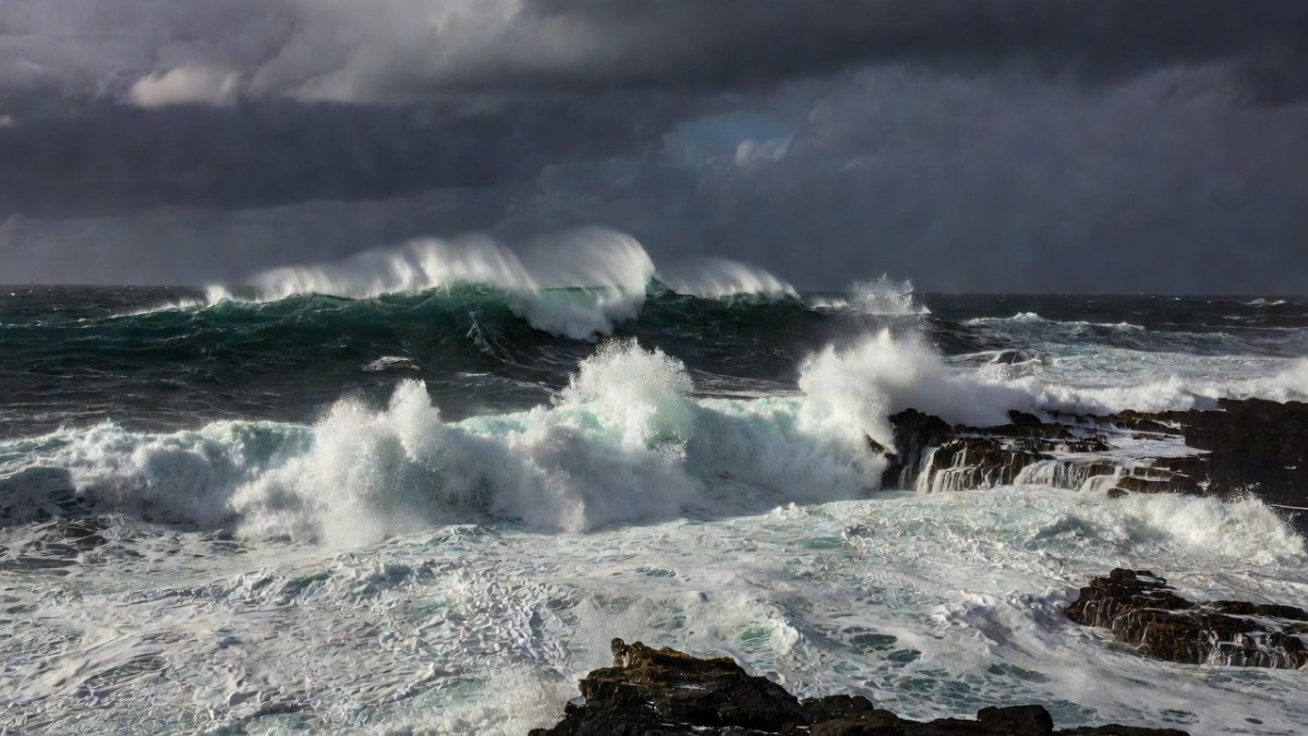 High surf crashing along a Hawaiian coastline as Hurricane Lowell approaches