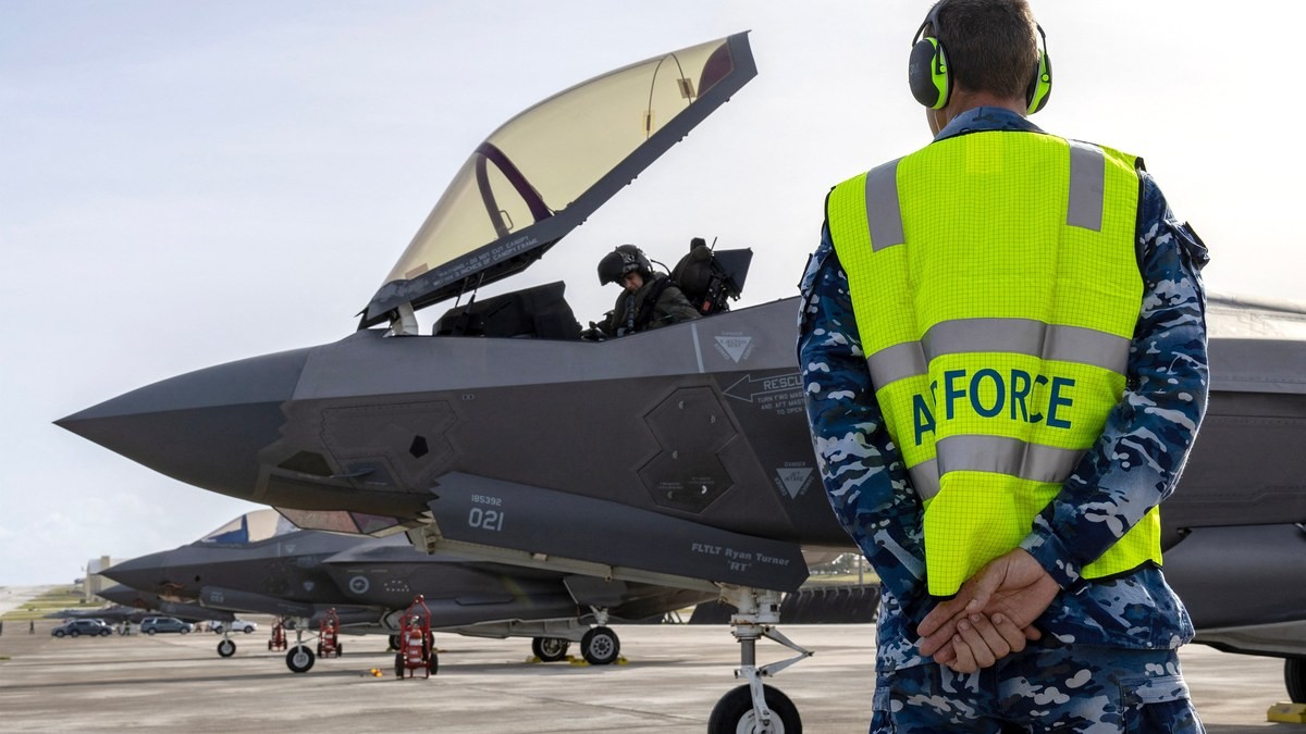 A Royal Australian Air Force ground crew member watches an F-35A Lightning II with its canopy open at Andersen Air Force Base in Guam. Photo: AFP