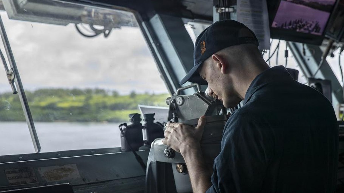 A quartermaster stands watch on the bridge of the USS Abraham Lincoln as the aircraft carrier arrives at Naval Base Guam on Sept. 19, 2026. Photo: Cesar Zavala Cordova/U.S. Navy