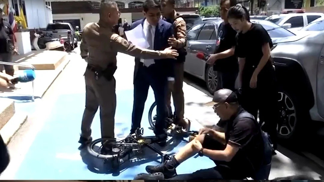 Somchai Srisutthiyakorn, a former Election Commission member, at Thong Lor police station in Bangkok after the confrontation on Friday