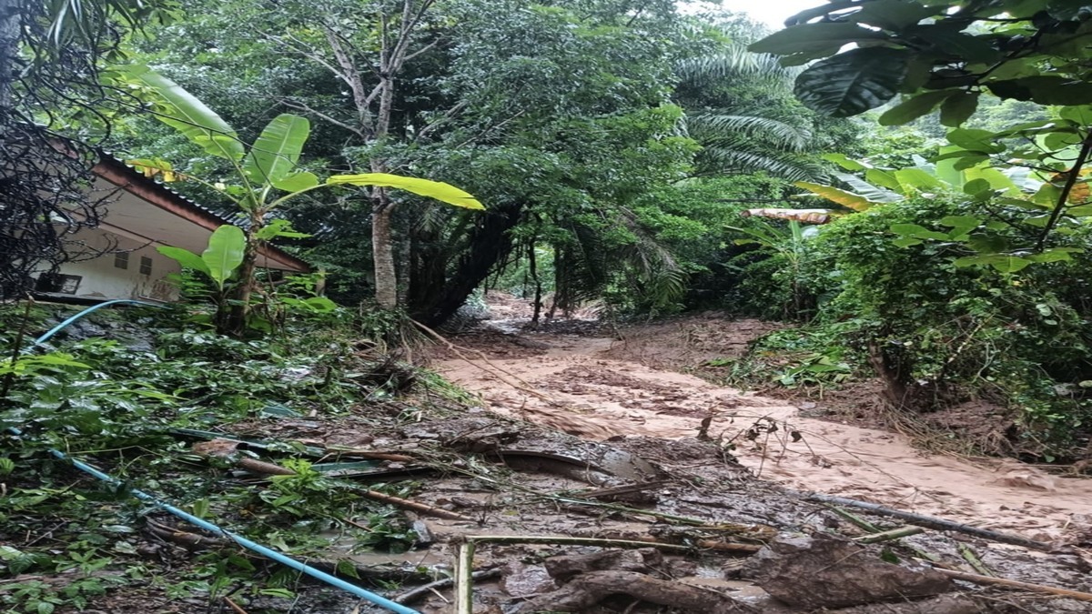 Mud and debris cover a path beside a building in eastern Thailand after heavy rain. Photo: Thai PBS