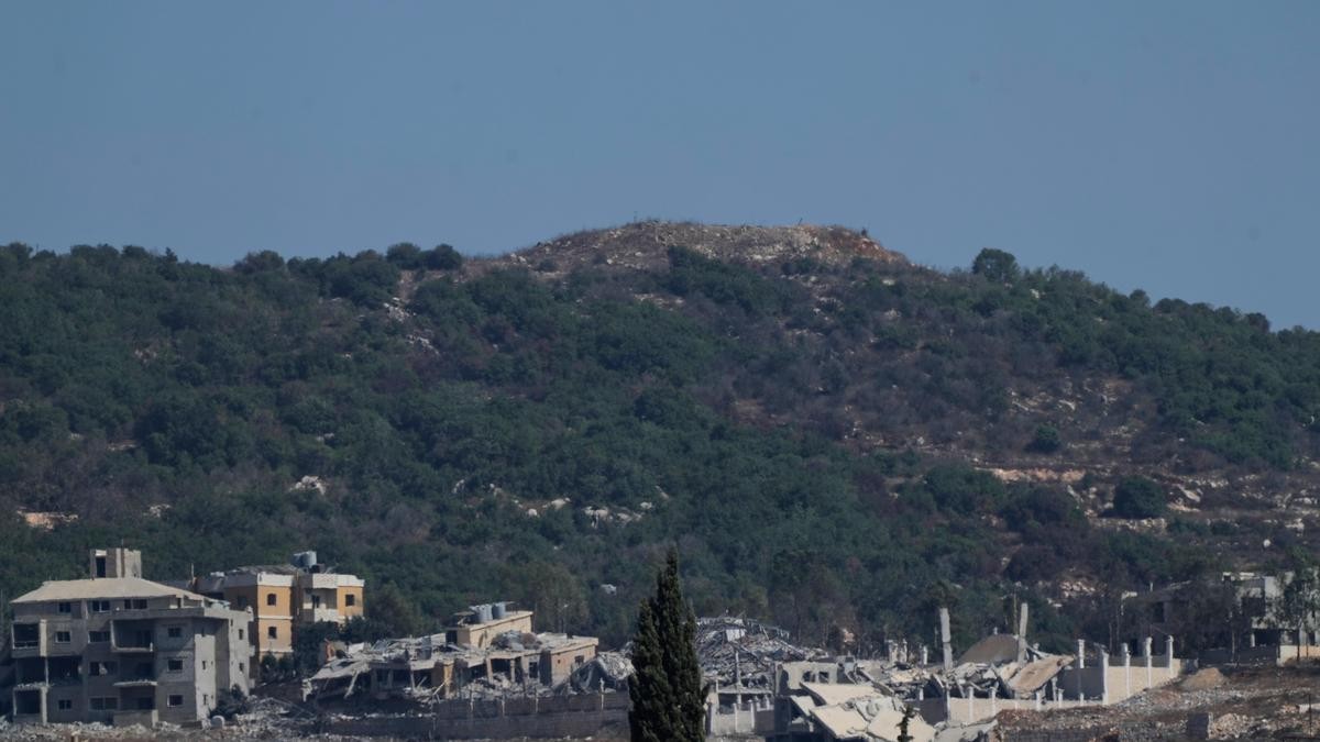 The Ali al-Taher ridge in southern Lebanon, with damaged buildings in the foreground