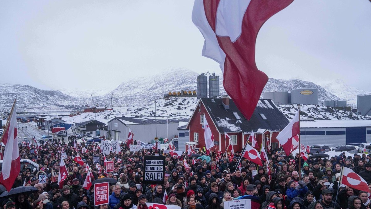 Demonstrators carry Greenlandic flags and placards reading "Greenland is not for sale" during a protest in Nuuk, Greenland in January 2026. Photo: Evgeniy Maloletka/AP