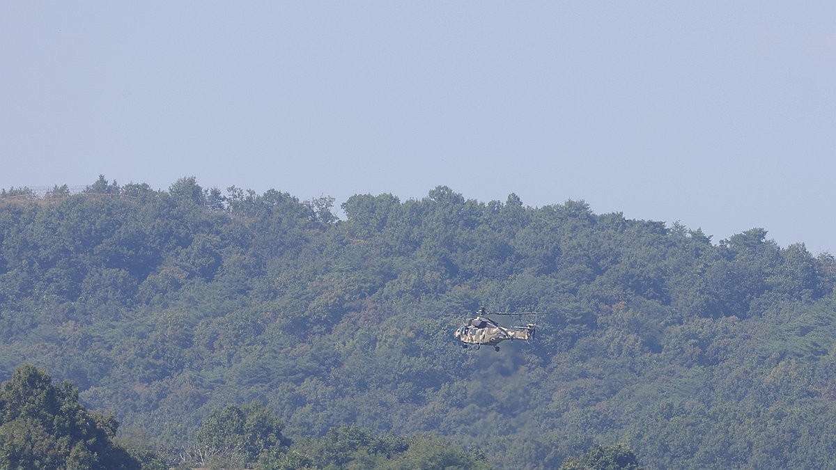 A South Korean Army helicopter flies above the western sector of the Demilitarized Zone in the border county of Paju on 22 September 2026, the day after the blast. Photo: Yonhap