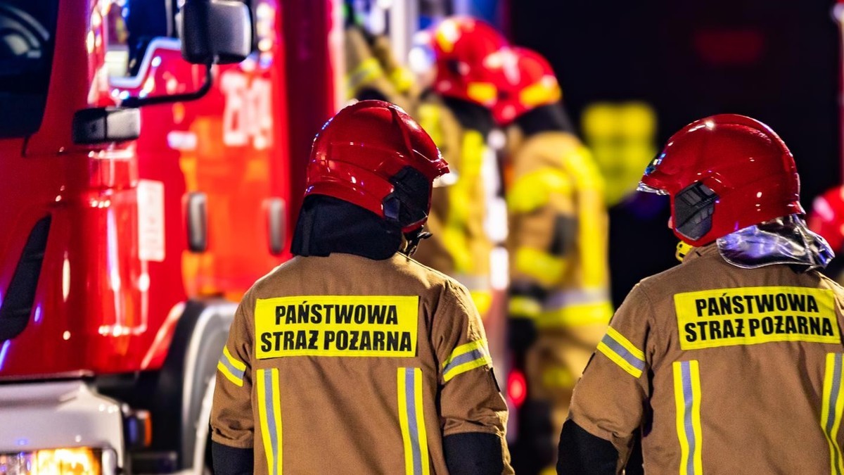Firefighters from Poland's State Fire Service at the scene of a night-time blaze. Photo: Notes From Poland