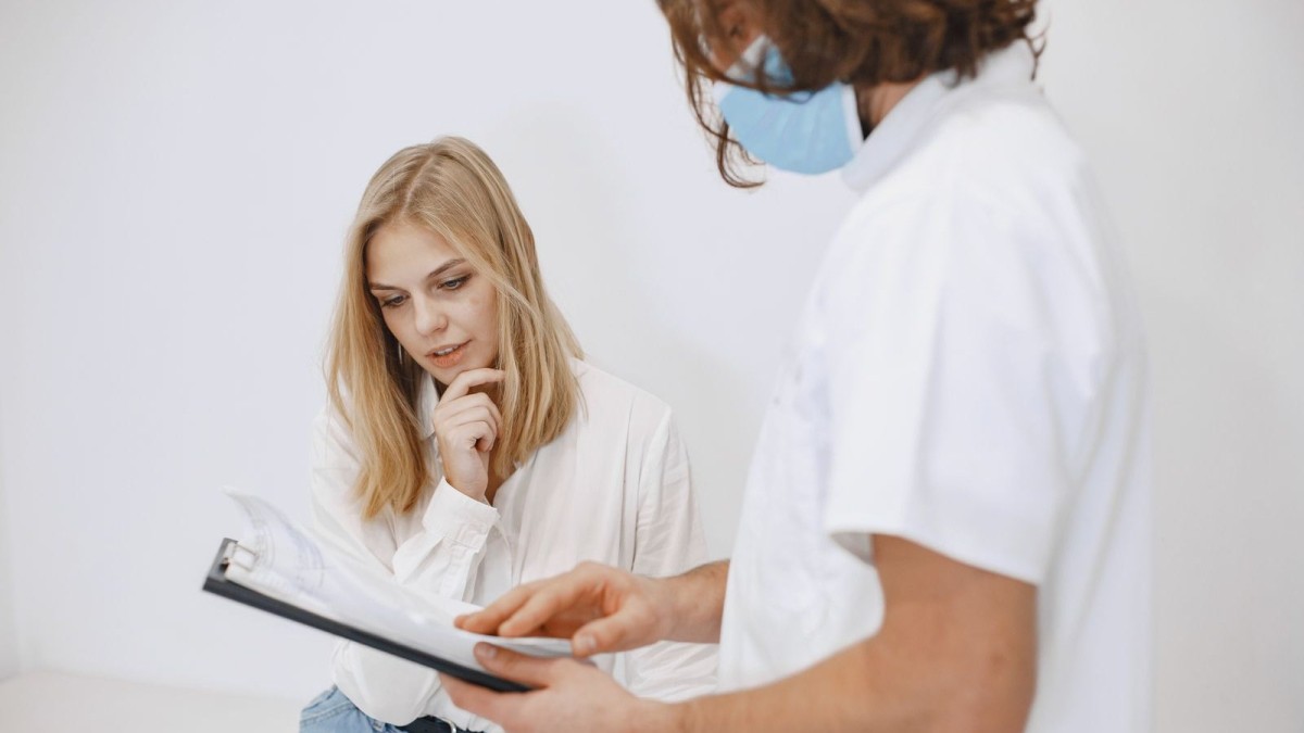 A healthcare worker in Thailand reviews test results with a young patient during an HIV counselling session
