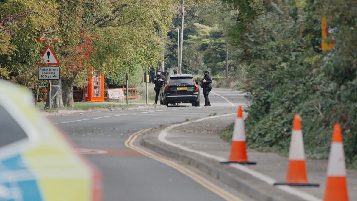 Police officers stand at a cordon on a rural road near RAF Fairford in Gloucestershire on 27 September 2026. Photo: PA Media via STV News