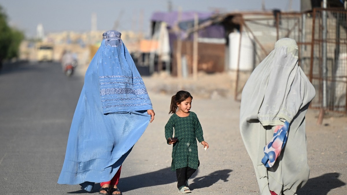 Afghan women and a girl walk along a street in Loy Viala village in Kandahar, Afghanistan, on 21 June 2026. Photo: Sanaullah Seiam/AFP