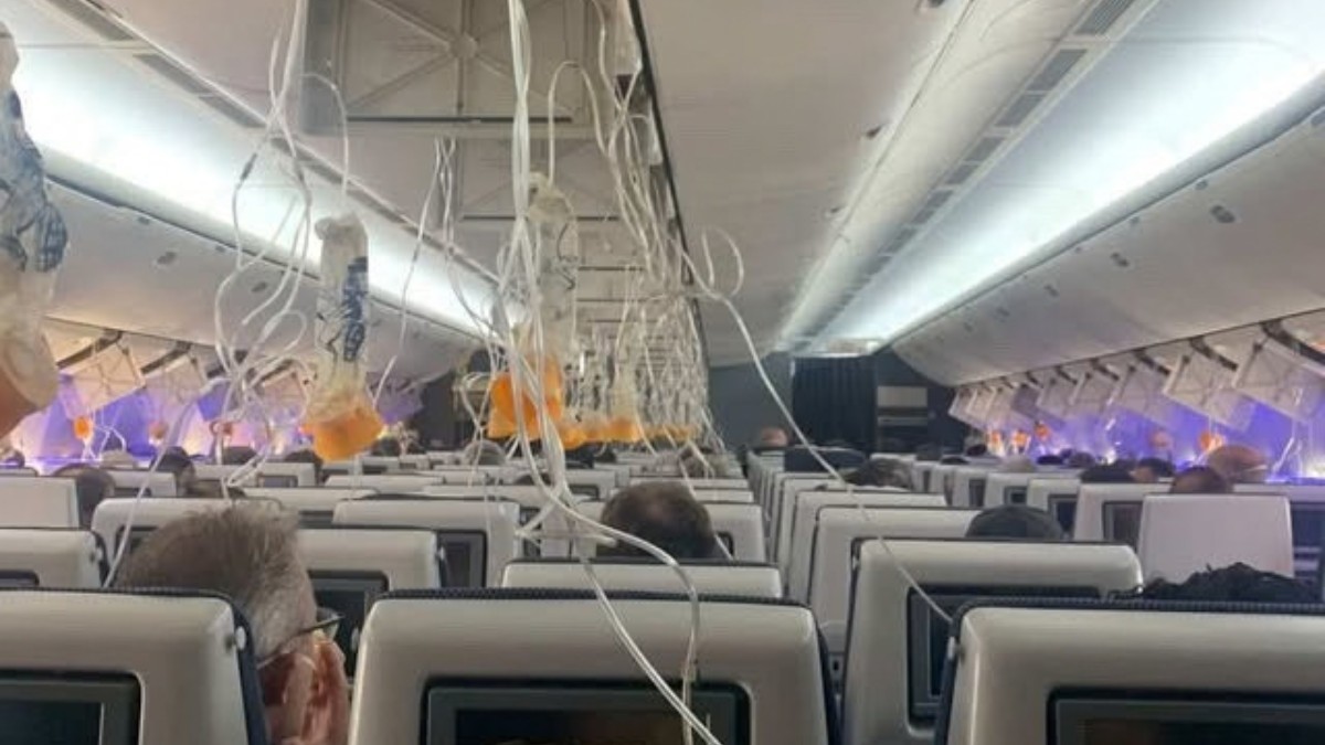 Oxygen masks hang from the ceiling inside a passenger cabin (file image).