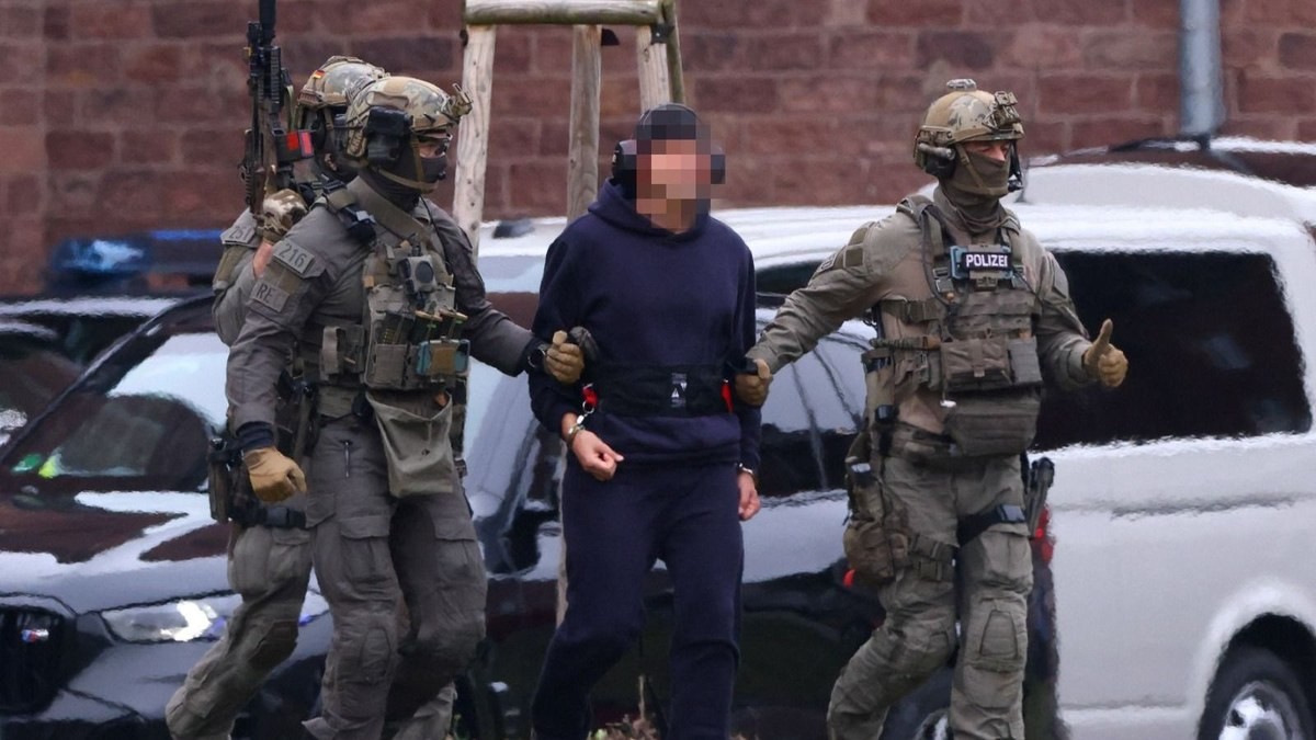 A former Ukrainian army officer identified by the German court only as Serhii K. is escorted by armed police. Photo: Reuters