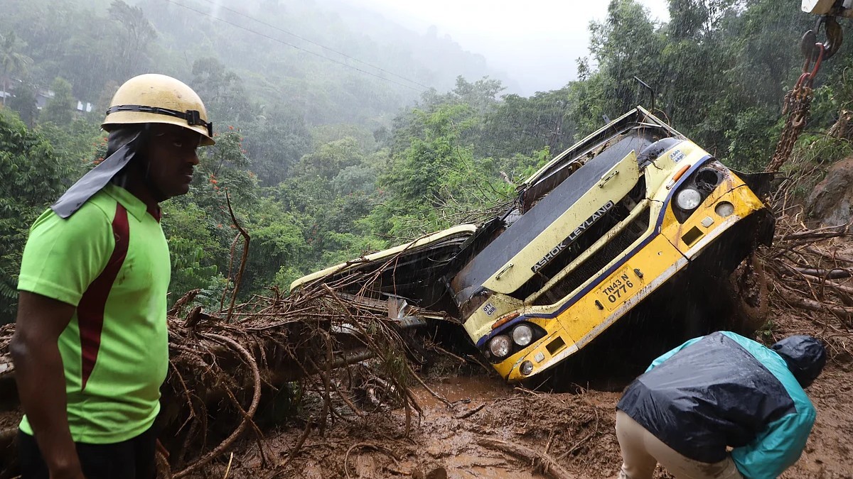 Tamil Nadu Disaster Response Force personnel at the wreck of a state transport bus buried by a landslide at Burliyar on the Coonoor-Mettupalayam ghat road in the Nilgiris. Photo: S Senbagapandiyan / The New Indian Express