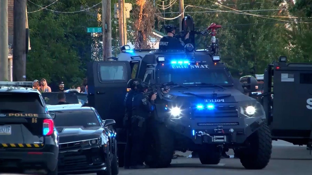 Police officers and a SWAT armored vehicle line a residential street in Erie, Pennsylvania, after a shooting on Perry Street. Photo: FOX 29 Philadelphia