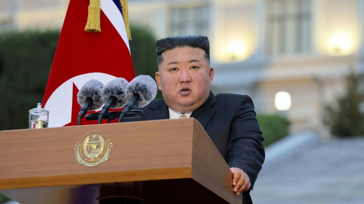 North Korean leader Kim Jong Un speaking at a podium with microphones and a North Korean flag behind him, in a photograph released by KCNA. Photo: KCNA via AFP