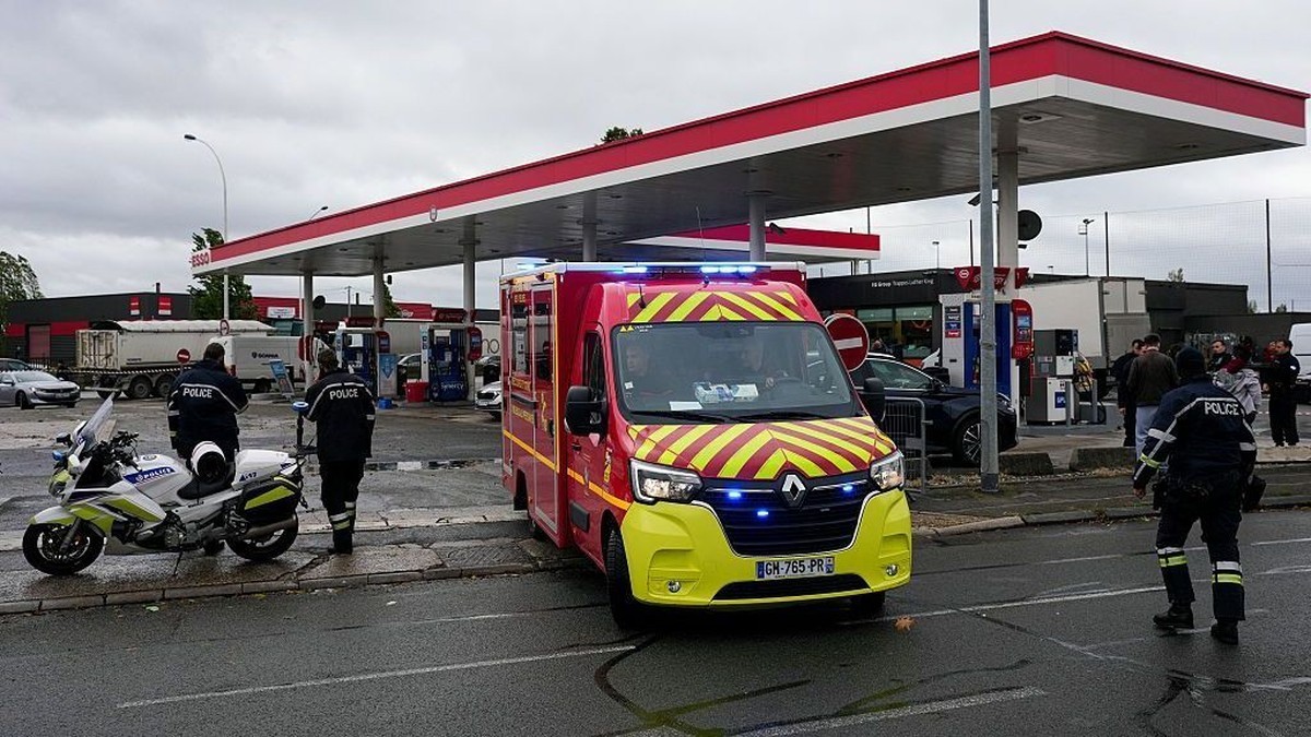 French firefighters and police at a petrol station cordoned off after a gunman opened fire from his car in the Trappes area on 23 October 2026. Credit: Getty Images