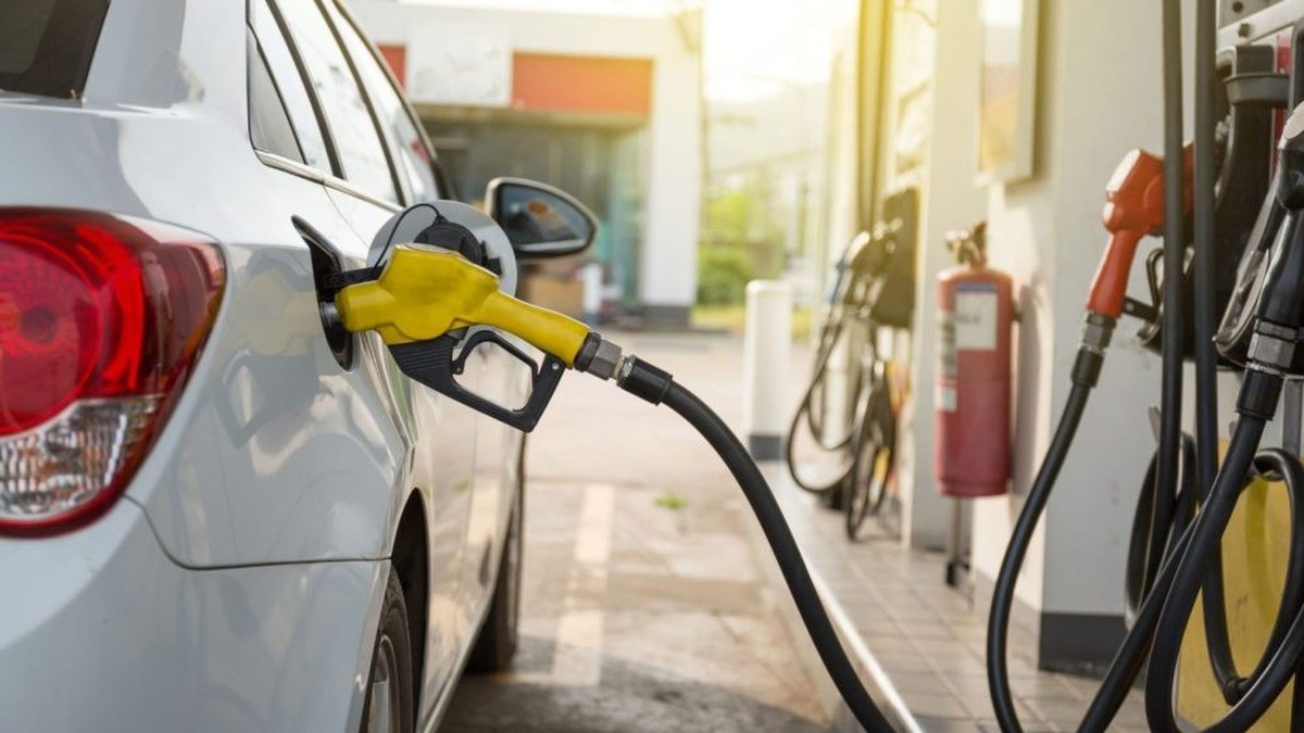 A driver refuels a car at a fuel pump as gasoline prices climb. File image.