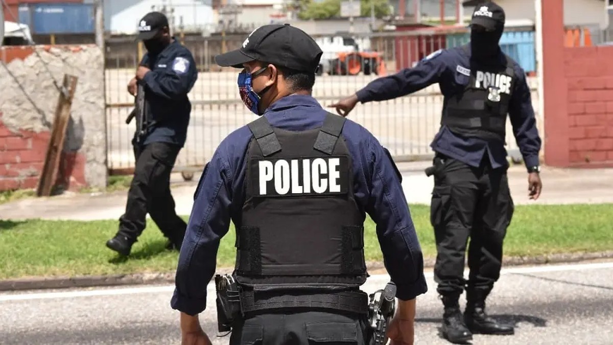 Armed police officers stand on a street in Trinidad and Tobago, where the Special Operations Act, 2026 now allows warrantless searches inside declared closed areas. (Nationwide Newsnet)