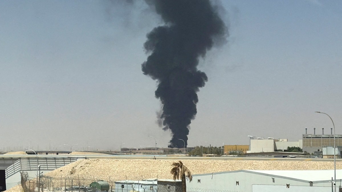 Thick black smoke rises from an industrial area. Photo: Reuters via Al Jazeera