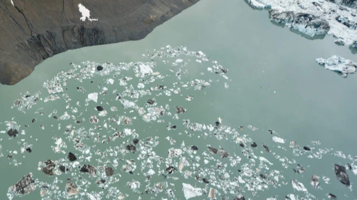 A glacial lake with broken ice floating at the foot of a glacier, in an image published with the Economic Times report on the Bhutan outburst.
