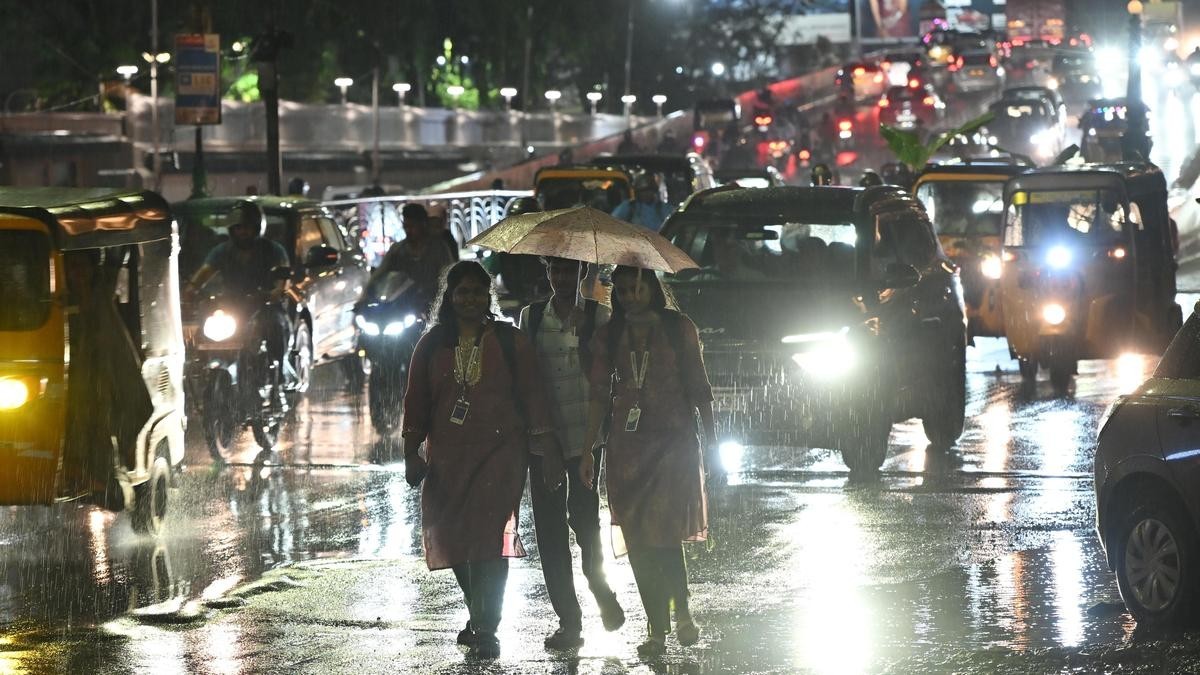 Pedestrians walking under an umbrella on a rain-soaked city street in Chennai as the northeast monsoon brings heavy rain to Tamil Nadu. Photo: B. Velankanni Raj / The Hindu