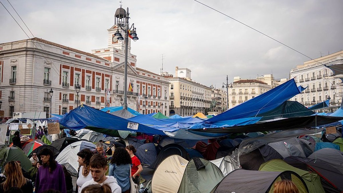 Protesters camp in Madrid's Puerta del Sol square, where hundreds of tents have been pitched over the housing crisis, with the Real Casa de Correos clock tower behind. Photo: Europa Press via Getty Images