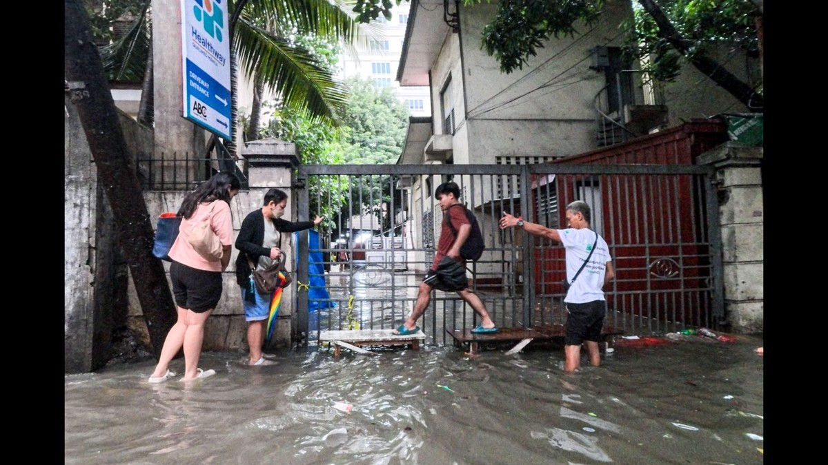 Residents wade through floodwater along Taft Avenue in Manila on 10 August 2026, after monsoon rains intensified by tropical cyclones. Photo: Rappler