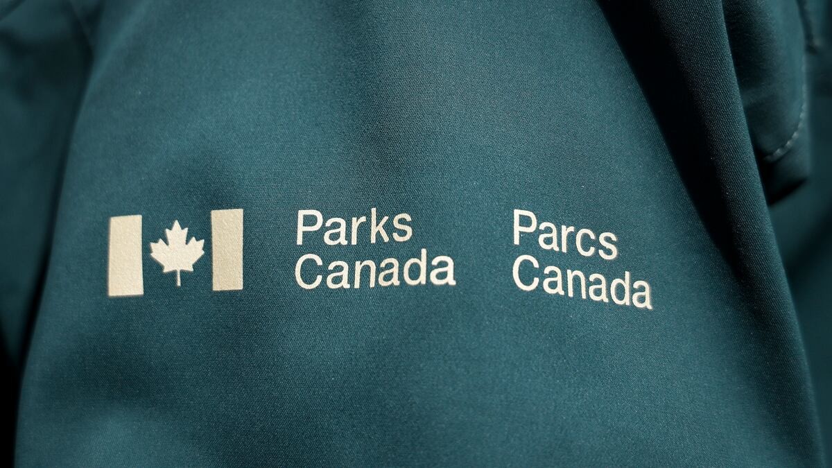 A Parks Canada uniform shirt bearing the bilingual Parks Canada and Parcs Canada crest. Photo: Jeff McIntosh/The Canadian Press