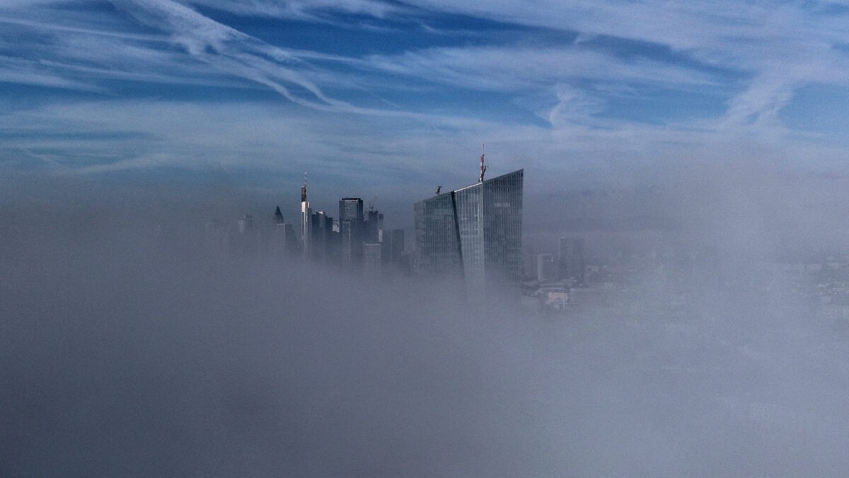 Fog over the Frankfurt skyline on 29 October 2026, the day the European Central Bank announced its president would leave early. Photo: Michael Probst/AP
